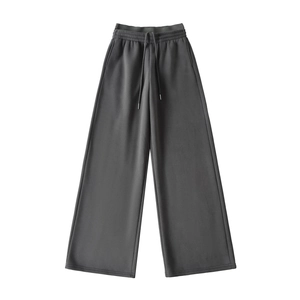 Detail of high-waist elastic waistband and adjustable drawstring on dark grey sweatpants