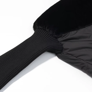 Detail of knit cuff and premium black faux fur trim on winter jacket fabric