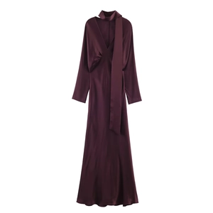 Detail of burgundy satin maxi dress featuring V-neckline and decorative neck scarf detail