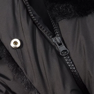 Detail of winter coat with black zipper, silver snap button and faux fur lining texture