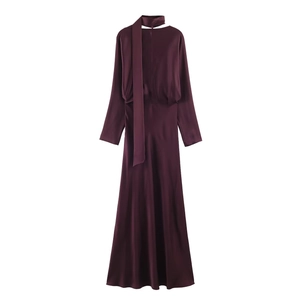 Detailed view of dark purple satin dress featuring a long scarf tie V-neckline