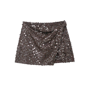 Detail of silver sequins on a wrap mini skirt with wave pattern and metallic texture