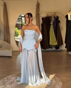 Detail of light blue strapless gown featuring pearl waist accents and sheer chiffon pleats