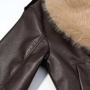 Detailed view of deep brown leather jacket with detachable khaki faux fur collar and stitching