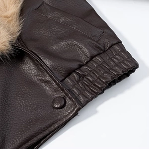 Detailed view of dark brown leather jacket with lychee texture and fur collar