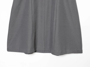 Close-up of eyelash lace hem and twill texture on dark grey slim fit dress