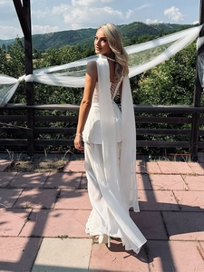 Detail of white halter backless top with long flowing streamers and cross-tie design
