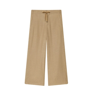 Detail of khaki wide-leg trousers with drawstring waist and textured fabric surface