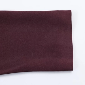 Detail of sleeve cuff on dark burgundy satin dress with smooth texture and clean finish