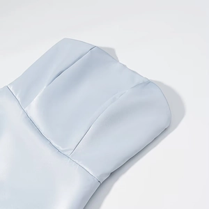 Detailed macro shot of light blue satin dress showing smooth texture and vertical seams