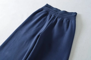 Detailed macro view of reinforced high-elastic waistband on navy fleece sweatpants