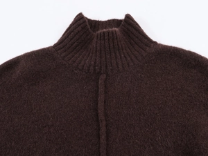Close-up of brown knit dress featuring ribbed high neck and fuzzy wool texture details