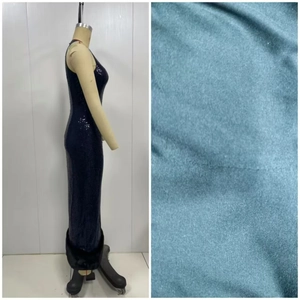 Close-up of sparkling navy sequins and faux fur trim on a sleeveless evening gown