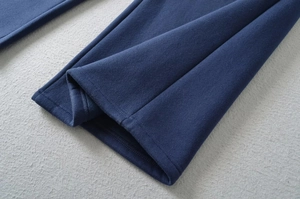 Detail of double-layered stitched hem on dark blue thick fleece-lined wide leg pants