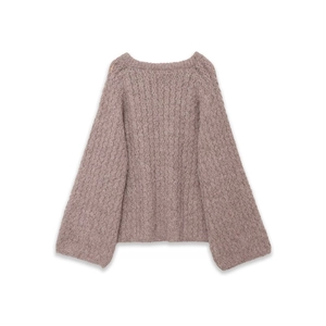 Close-up of pink bouclé knit sweater texture with soft fiber detail and ribbing