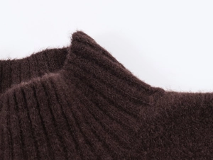 Detail of dark brown knit dress featuring ribbed high collar and fuzzy mohair texture