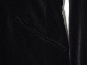 Detailed close-up of side pocket on black velvet long-sleeve romper jumpsuit