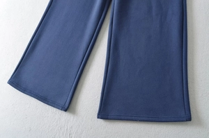 Detail shot of navy blue wide leg pants hem showing thick fabric texture and stitching