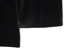 Close-up of premium black velvet fabric texture on the stylish double-breasted romper