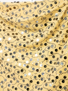 Detail of yellow sequin mini skirt with wave embroidery and shiny metallic accents