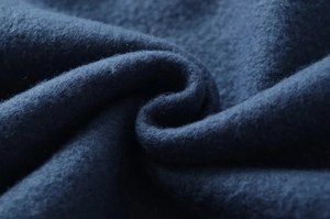 Macro shot of deep blue thickened fleece lining showing soft texture and premium material