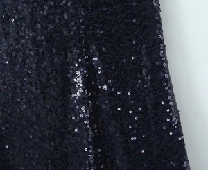 Detailed macro view of densely sewn round sequins on party dress fabric texture