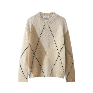Close-up of diamond argyle knit texture and brand label on winter crewneck sweater