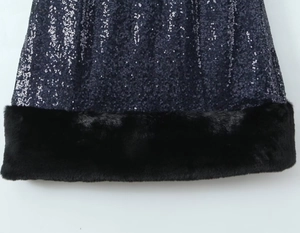 Detail of dark blue sequined dress featuring a luxurious black faux fur hemline