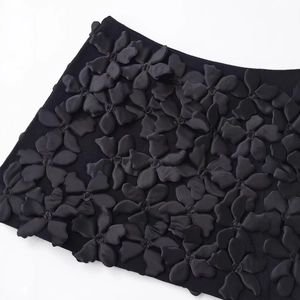 Mini-jupe tricotée noire pour femmes avec appliques florales 3D élégantes en satin