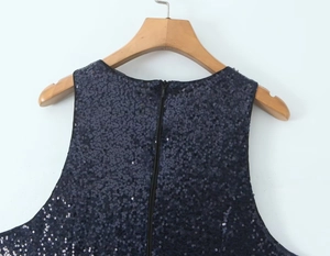 Detail of navy blue sequin dress featuring invisible back zipper and round neckline