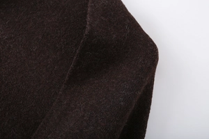 Close-up of deep coffee wool fabric showing the soft knitted texture and thick winter material