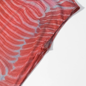 Detail of red and blue abstract pattern mesh fabric with fine stitching on women suit