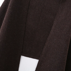 Macro shot of dark brown knitted fabric detail showing thick texture and soft fibers