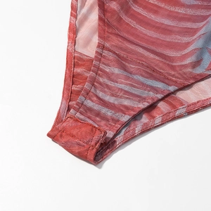 Detailed close-up of striped mesh bodysuit bottom gusset with snap button closure