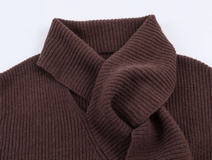 Detail of dark brown chunky knit sweater with unique criss-cross layered collar design