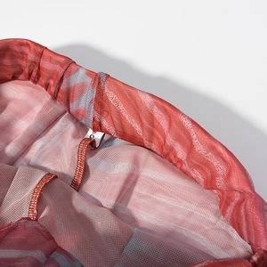 Macro shot of abstract print mesh skirt waistband with S-size label and neat stitching