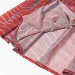 Detail view of the red tie-dye mesh fabric with fine lining and durable edge stitching