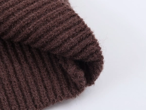 Macro detail of dark brown ribbed knit fabric with soft mohair texture for winter sweater