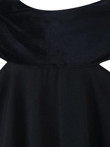 Détail du corsage en velours noir avec découpes à la taille et texture de tissu tissé