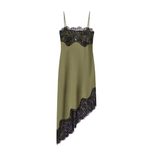 Detail of olive green satin dress featuring black floral lace and asymmetrical hem
