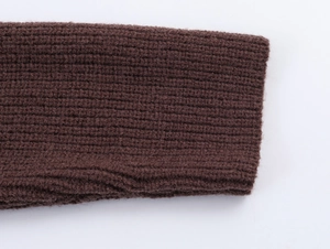 Close-up detail of dark brown ribbed knit cuffs on a stylish winter sweater for women