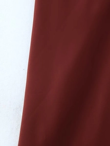 Macro detail of high-quality dark reddish-brown midi dress fabric texture and finish