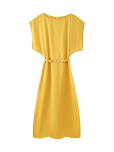 Detail of elegant mustard yellow midi dress featuring a refined metal chain belt and silk texture