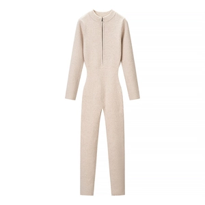 Detail view of the sleek zip-up neckline on this beige knit long-sleeve bodysuit