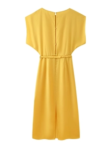 Detail of yellow satin midi dress featuring back button closure and elegant pleated waistline