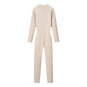 Detailed view of beige ribbed knit bodysuit with long sleeves and high waist cut