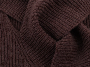 Close-up of deep brown ribbed knit fabric showing thick texture and vertical pattern