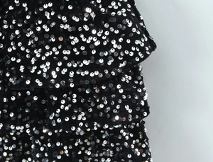 Detail of velvet dress with tiered layers and shimmering silver sequins for a luxury look