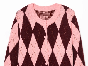 Close-up of pink and deep red argyle knit cardigan with round neck and buttons