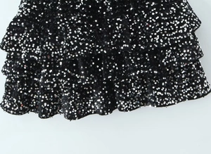 Detailed close-up of layered black sequin ruffles on a vintage sleeveless dress
